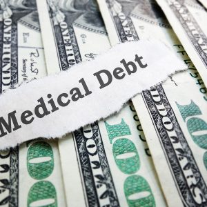 Medical Debt message on paper with hundred dollar bills